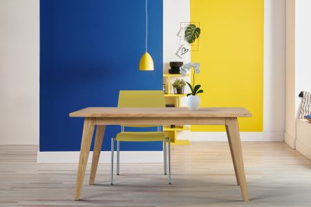 Yellow and blue wall background, interior style, round wood, frame and lamp.