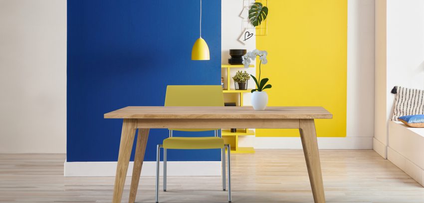 Yellow and blue wall background, interior style, round wood, fra Yellow and blue wall background, interior style, round wood, frame and lamp.